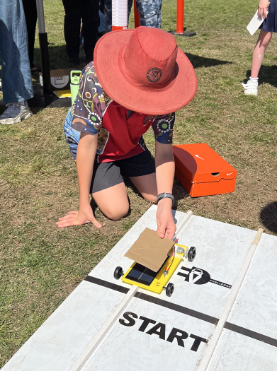 A senior student getting his EV vehicle ready to race at the Tighes Hill TAFE EV competition.