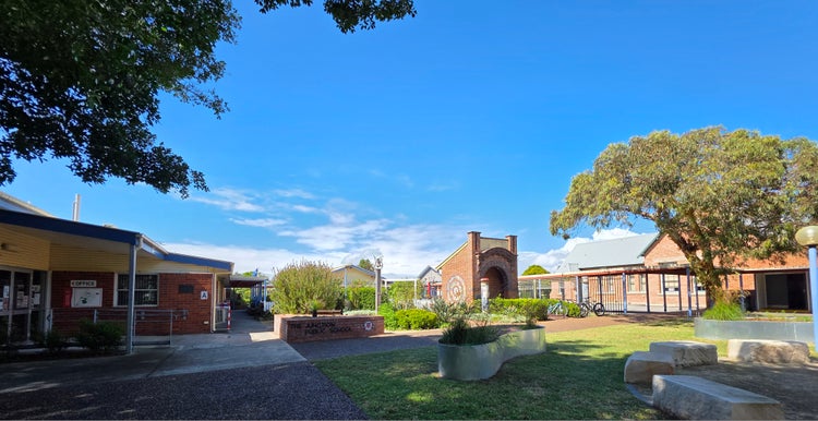 Image of school buildings and garden from the front gate.